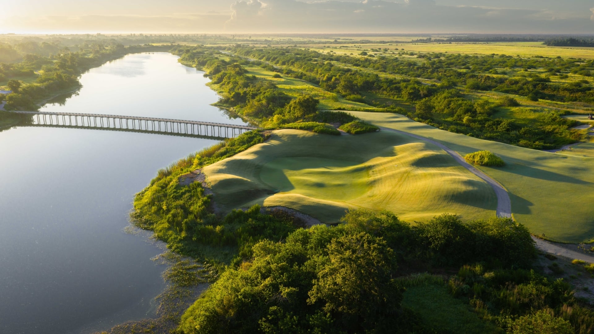 Aerial view of The Chain's 11th hole beside the trestle bridge at Streamsong